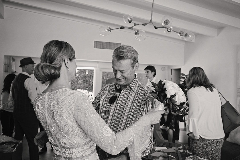 Bride shares an emotional moment with her father inside a Palm Springs home on her wedding day.