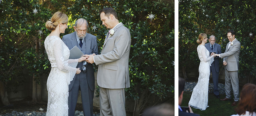 Bride and groom exchange rings during an intimate backyard ceremony in Palm Springs, surrounded by greenery and loved ones.