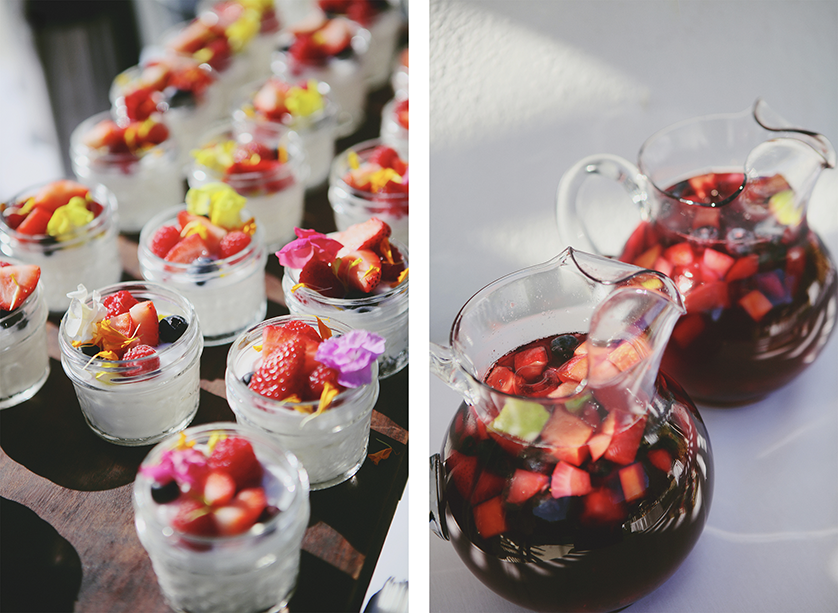 Mini dessert cups topped with fresh berries and edible flowers; pitchers of red sangria with chopped fruit.