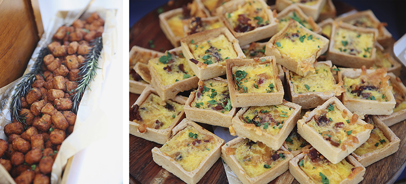 Crispy tater tots garnished with rosemary and mini square quiches topped with herbs served at a wedding reception.