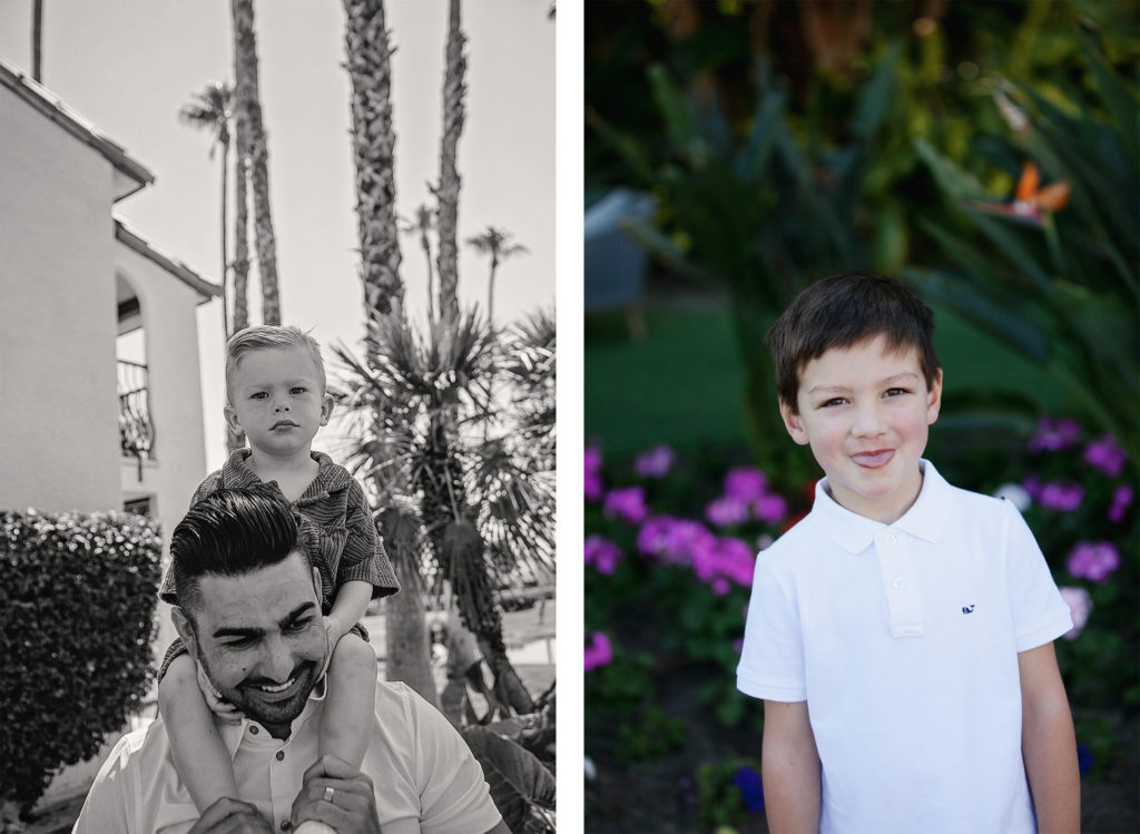 A smiling father carries his serious-faced son on his shoulders near palm trees, while another boy stands in front of vibrant flowers, playfully sticking out his tongue.
