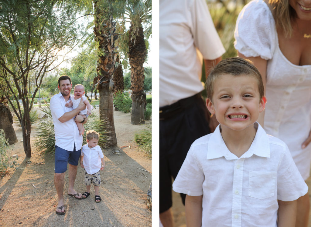 A father holds a crying baby while standing with two young boys among palm trees, and a boy in a white shirt flashes a silly grin in a family photo.