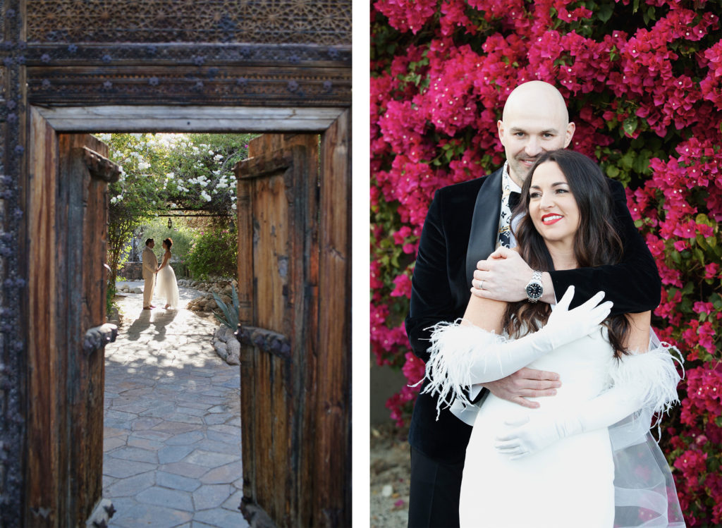 Bride and groom stand hand in hand beneath flowering vines, framed by a rustic wooden doorway.  Groom embraces his bride against a wall of vibrant pink bougainvillea, both smiling with joy.
