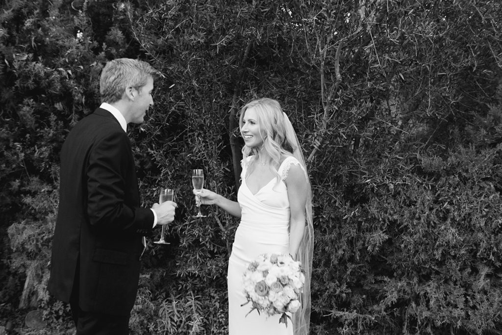 Bride and groom share a toast with champagne glasses during their wedding at the Parker Hotel in Palm Springs.