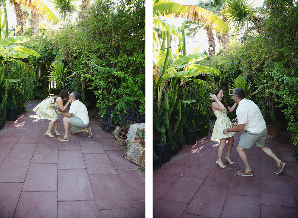 Couple celebrates after a surprise proposal at Casa Monte Vista in Palm Springs, sharing a kiss and joyful laughter among lush desert greenery.
