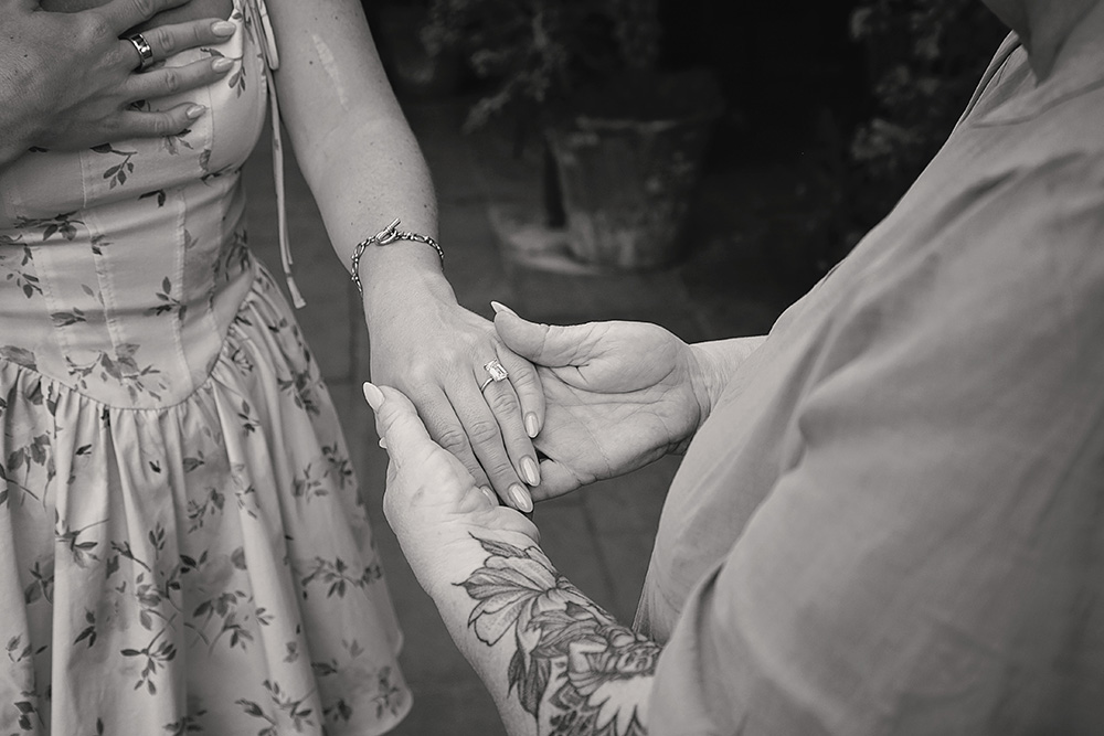 Close-up of hands as a woman proudly shows her new engagement ring during a surprise proposal at Casa de Monte Vista in Palm Springs.