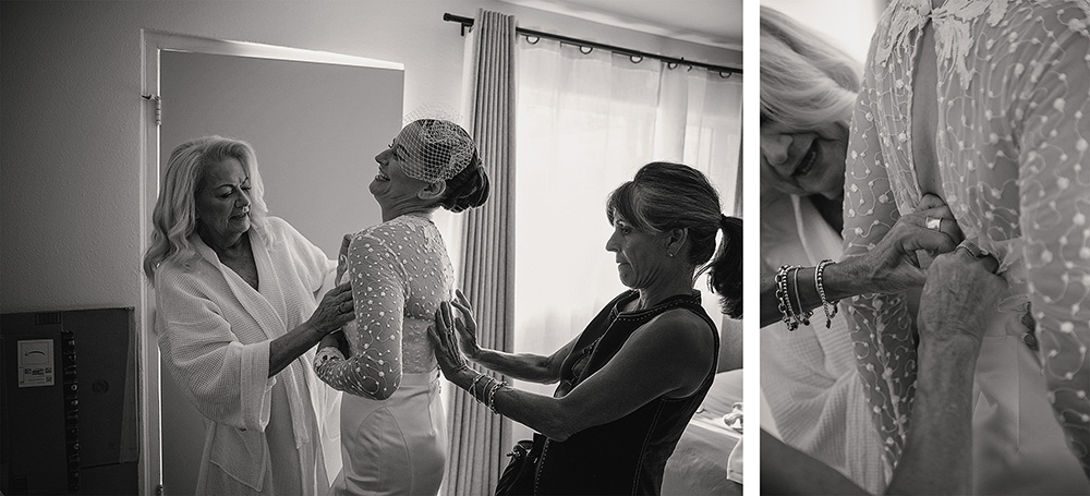 Bride being helped into her wedding dress by loved ones during an intimate boutique hotel wedding at Skylark Hotel, captured in black and white documentary wedding photography