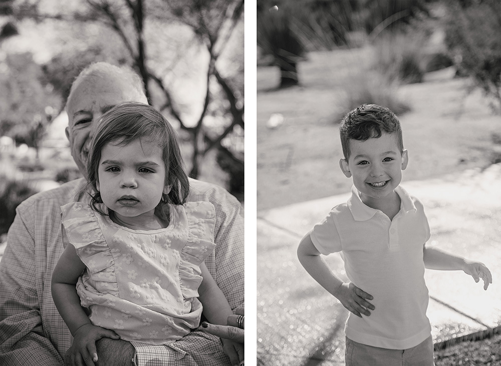 Young girl sitting on a grandparent’s lap outdoors in Palm Springs, looking calmly at the camera.

Right Image

Smiling young boy standing in desert sunlight in Palm Springs, posing playfully with one hand on his hip.
