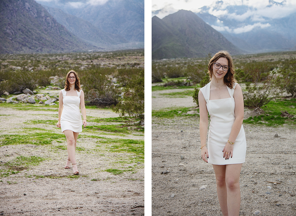 High School senior walks through desert scenery, smiling at the camera