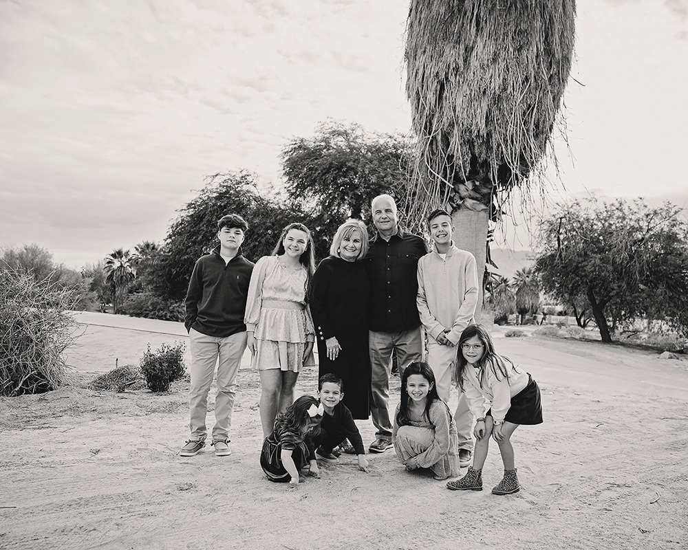 Black and white photo of grandparents with all of their grandchildren surrounding them.