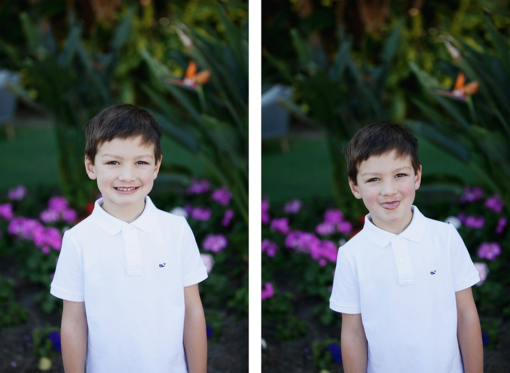 A young boy in a white polo shirt poses for photos in front of a lush garden setting