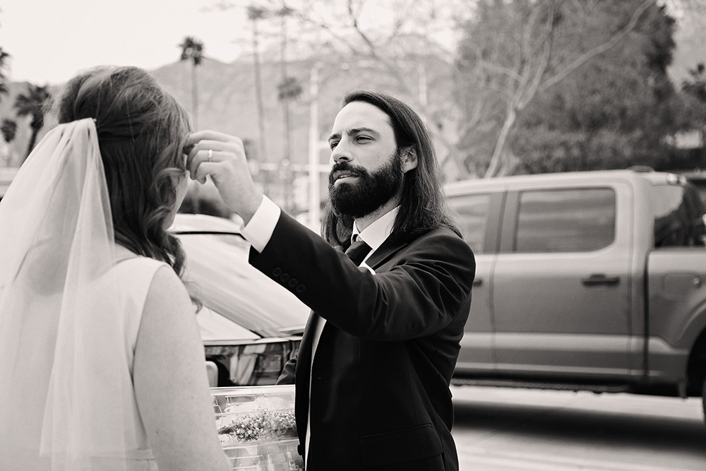 Groom takes a moment to fix his brides hair