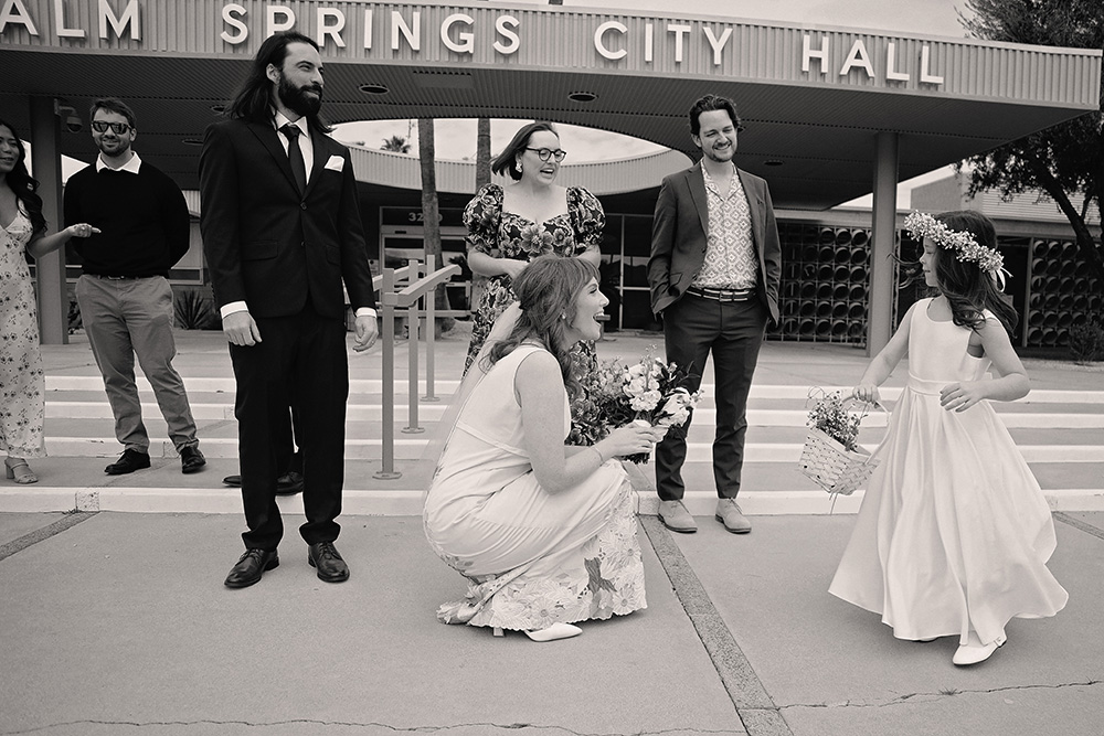 A sweet black and white image captures a moment of joy between the bride and her niece 