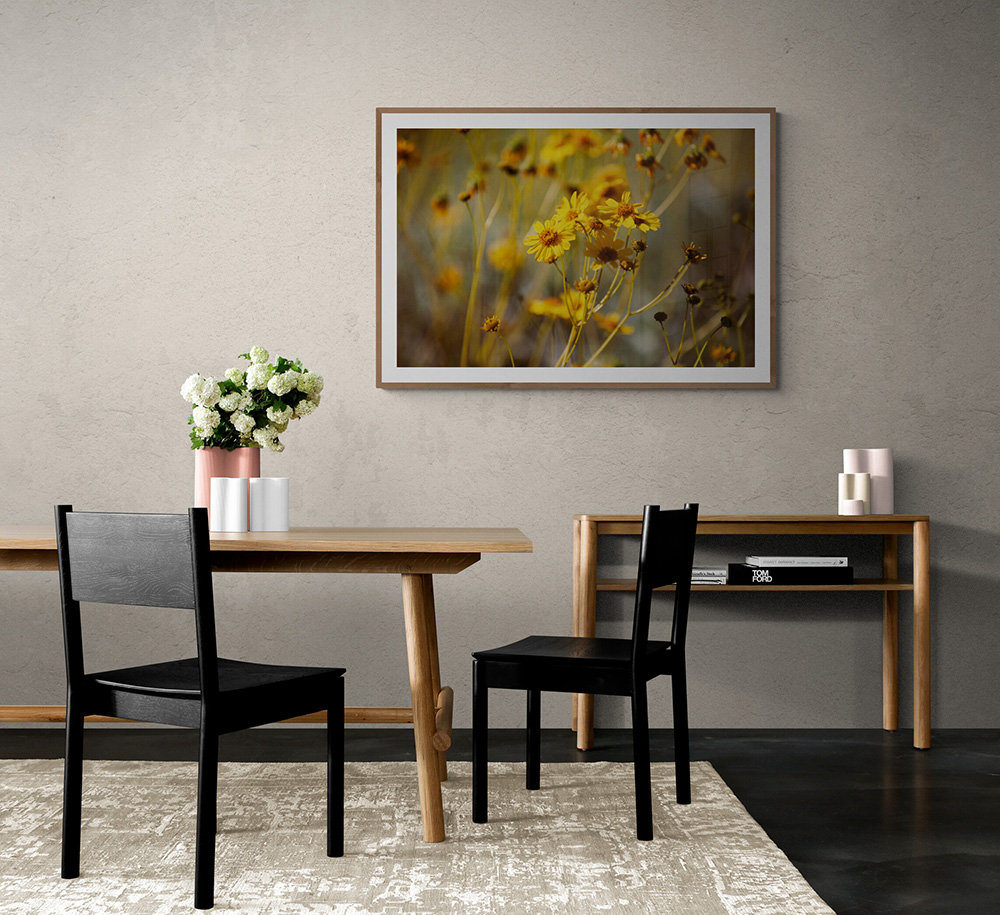 Image of a dining room with a pretty photograph on the wall