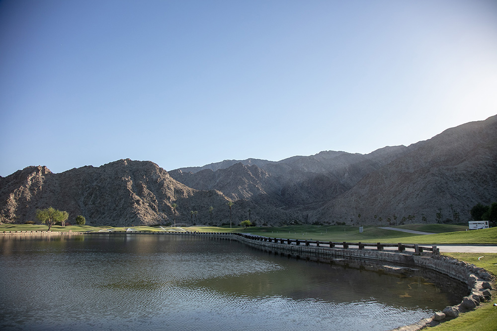 Sunset vista across a golf course with desert mountains