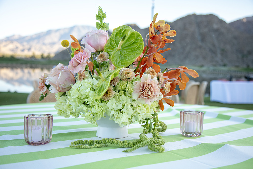 Floral centerpiece with variety of pink, green and orange flowers