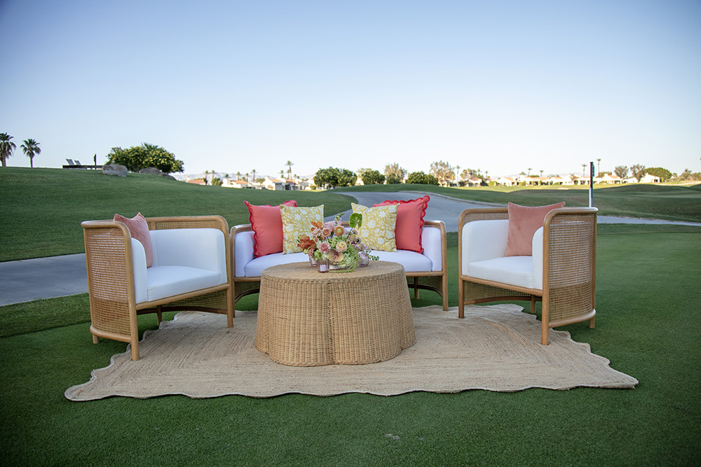 Chic seating area with wicker chairs and sofa and coffee table