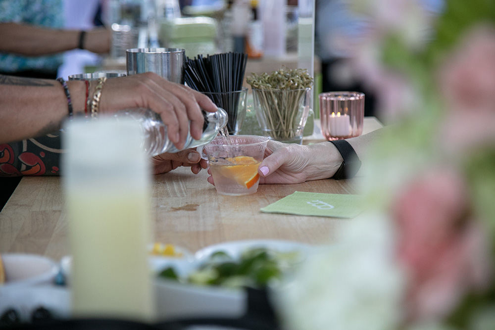 Detail photograph of a bartender filling a guests glass
