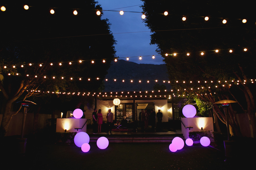 Outdoor courtyard at night, with bistro lights