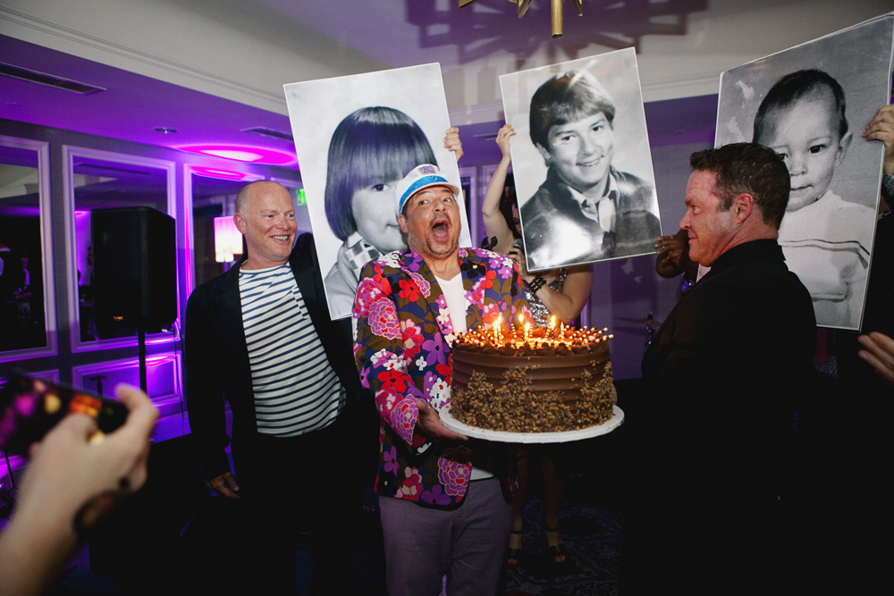 Man blows out candles on his birthday cake
