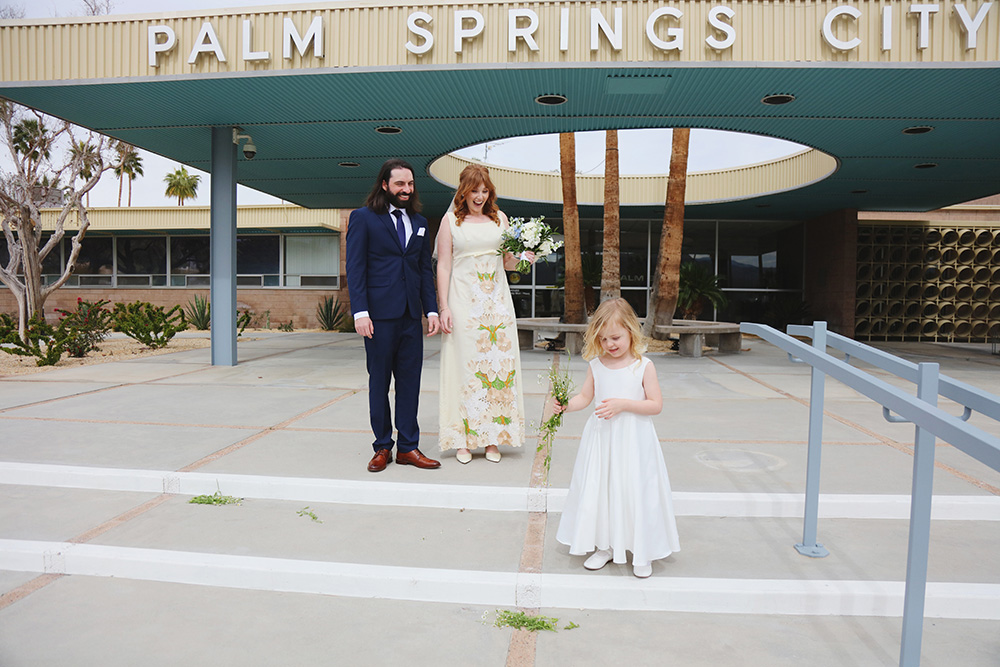Newlywed couple pose on steps of Palm Springs City hall