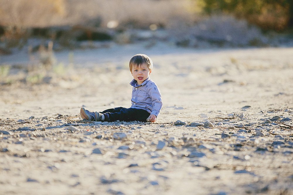 Toddler sits in the soft evening sun in Palm Desert