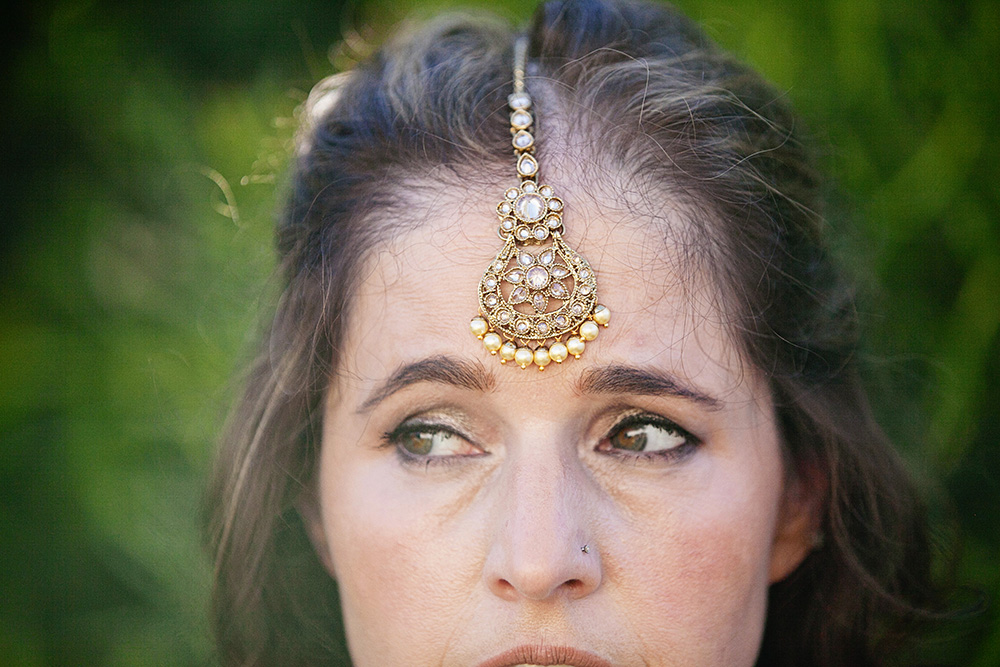 Detailed photo of a bride wearing her maang tikka