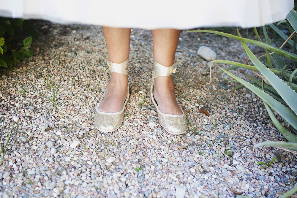 Closeup photograph of a brides ballet slipper style wedding shoes