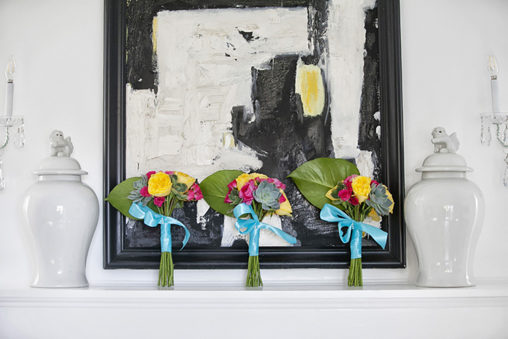 Three vibrant bouquets lined up on a mantle